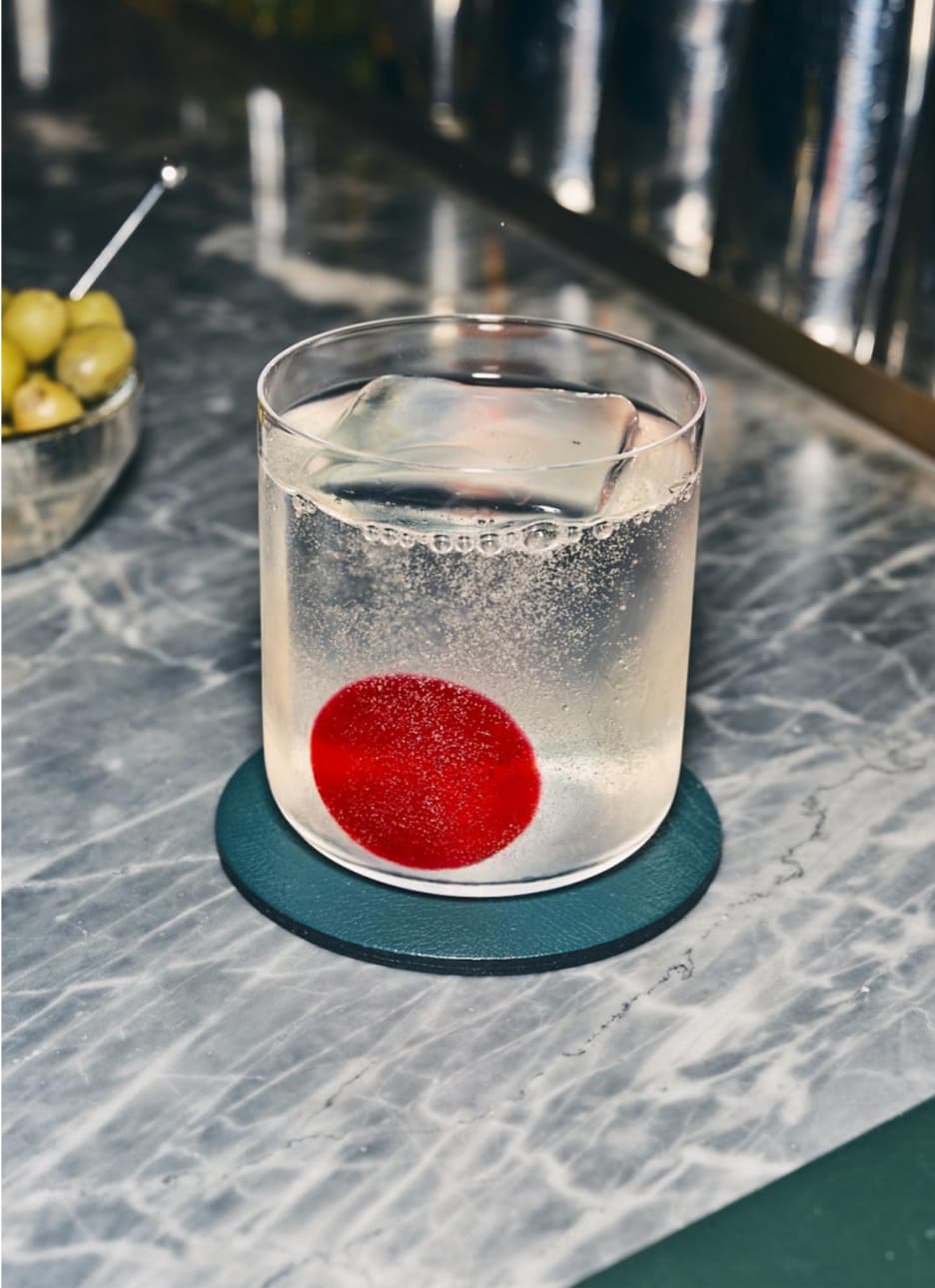 A Gin Rickey cocktail sitting on a bar