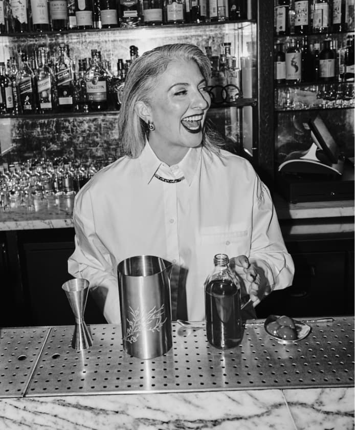 Giulia Cuccurullo standing behind a bar with a mixer in her hand