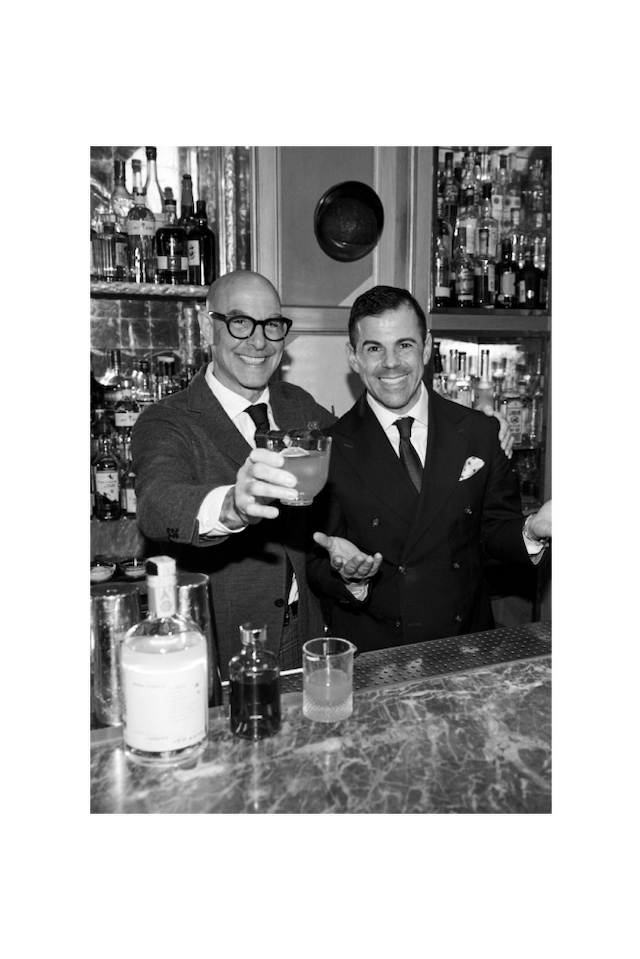Stanley Tucci and Ago Perrone behind a bar.