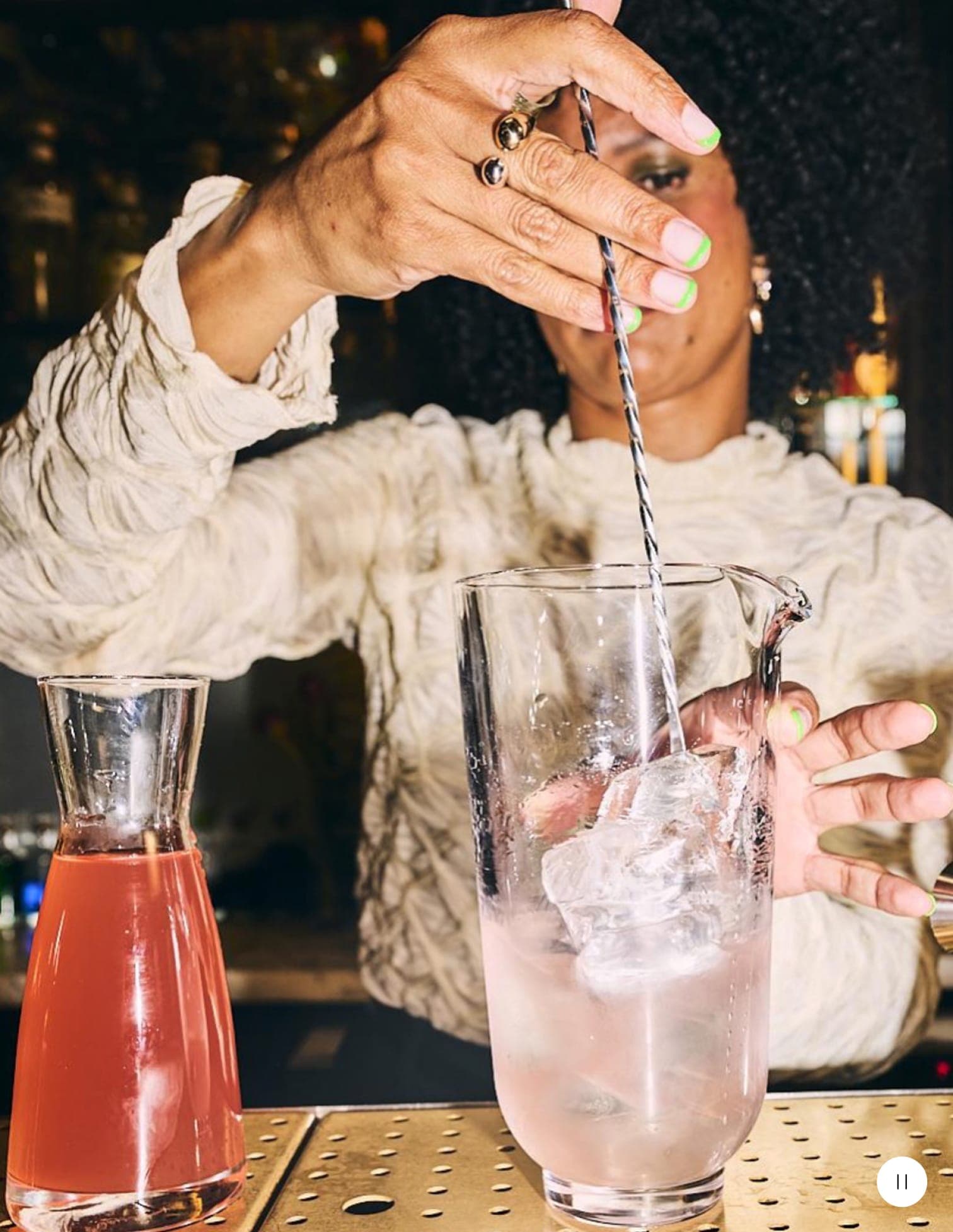 Juila Ba mixes a cocktail.