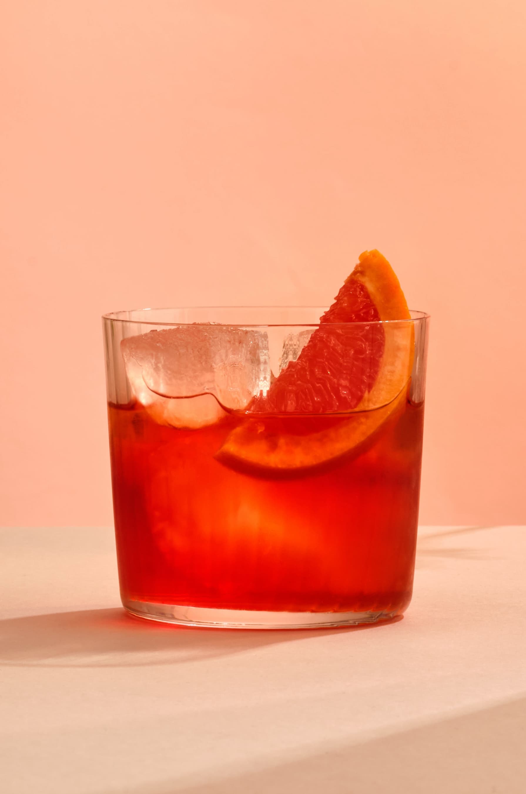 A Negroni cocktail made with Tanqueray Flor de Sevilla, garnished with a grapefruit slice.